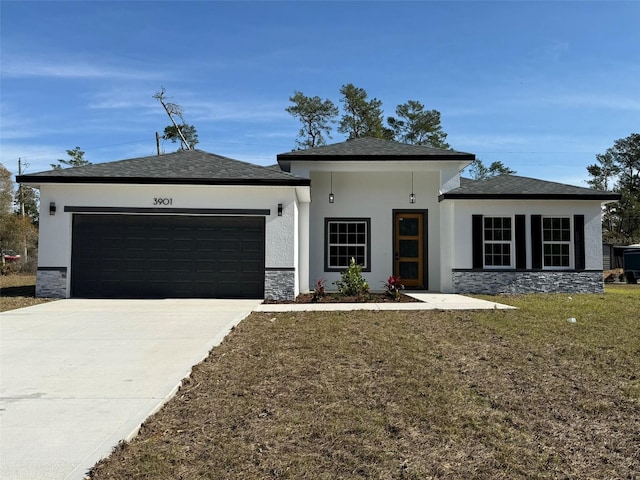 view of front of house featuring a front yard and a garage