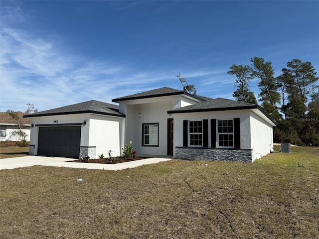 view of front of home with a front yard and a garage