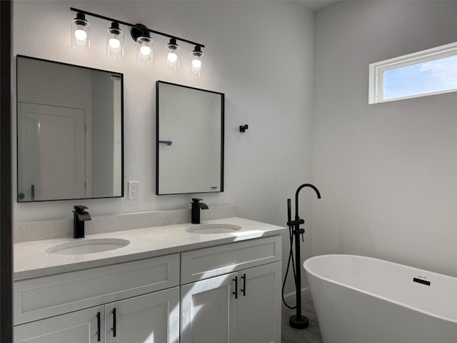 bathroom featuring vanity and a tub