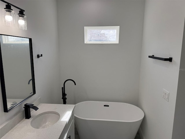 bathroom with vanity and a tub