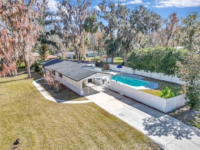 view of swimming pool featuring a yard and a patio area