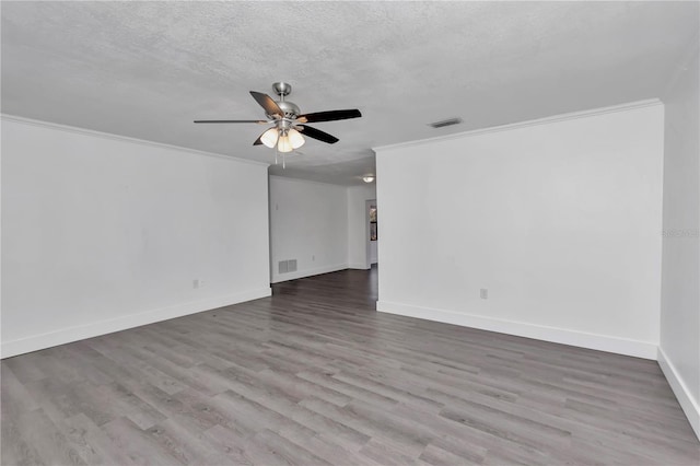 unfurnished room featuring crown molding, ceiling fan, wood-type flooring, and a textured ceiling