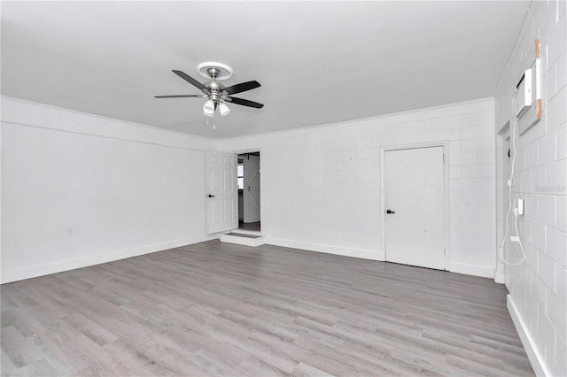 unfurnished room with hardwood / wood-style floors and ceiling fan