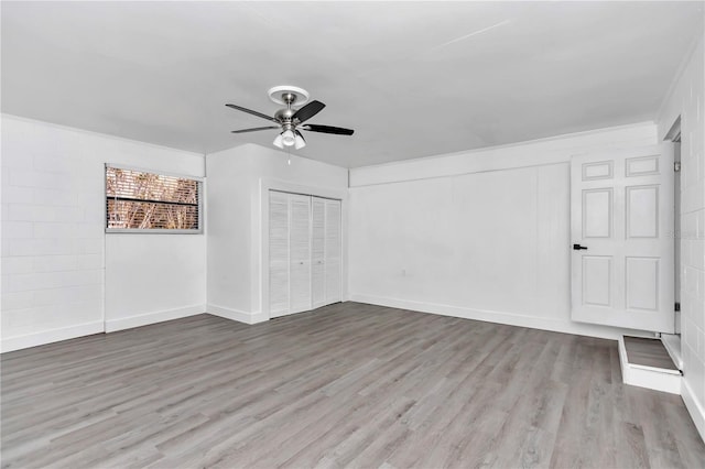 interior space featuring ceiling fan, light hardwood / wood-style floors, and a closet