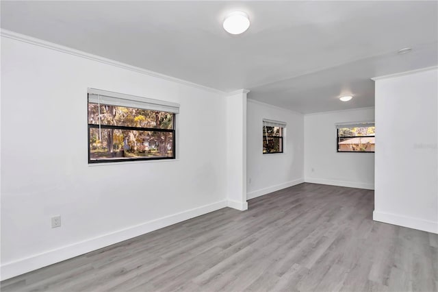 spare room with light hardwood / wood-style flooring and ornamental molding