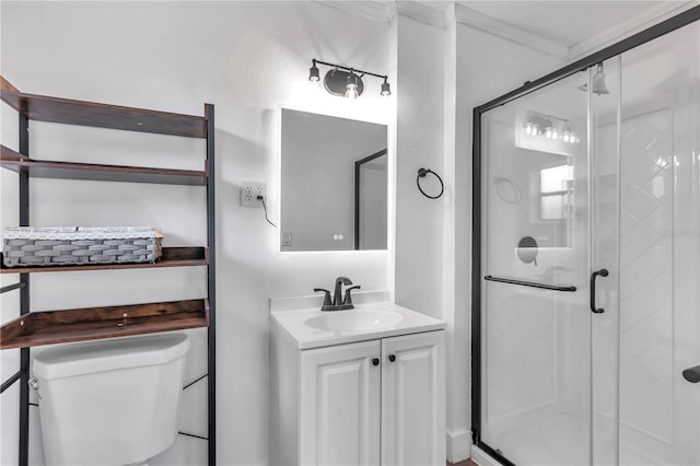 bathroom featuring vanity, a shower with door, and toilet