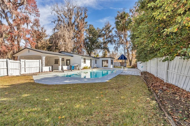 view of pool with a lawn and a patio area