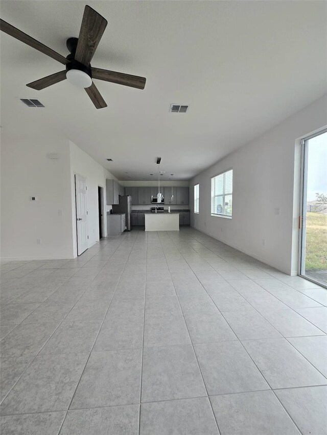 1603 Gardiner St, Haines City, FL 33844 - unfurnished living room with a ceiling fan, visible vents, and light tile patterned floors