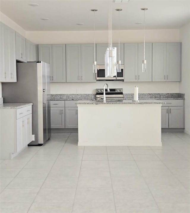 1603 Gardiner St, Haines City, FL 33844 - kitchen with an island with sink, decorative light fixtures, light stone countertops, stainless steel appliances, and gray cabinetry