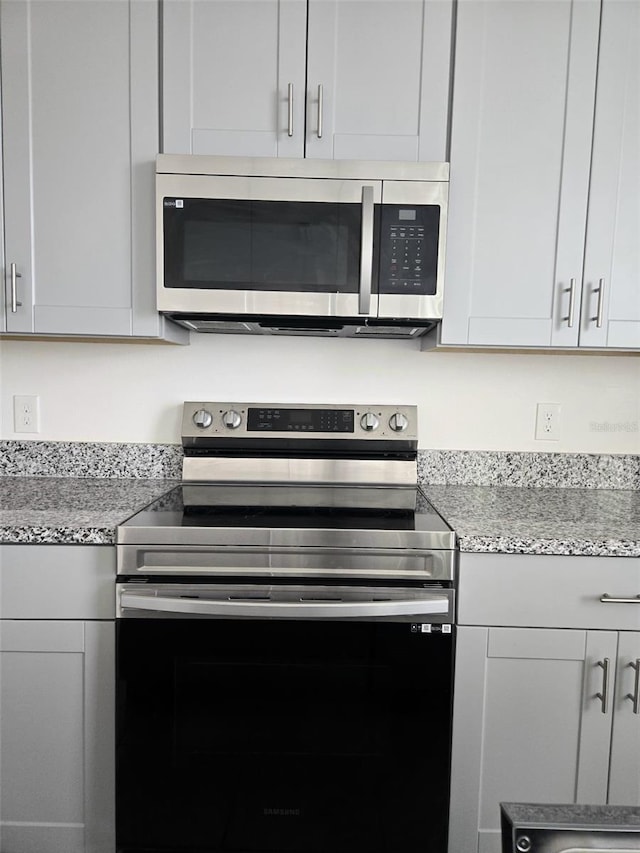 1603 Gardiner St, Haines City, FL 33844 - kitchen with stainless steel appliances and light stone counters