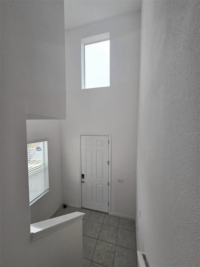 1603 Gardiner St, Haines City, FL 33844 - foyer entrance featuring baseboards, light tile patterned flooring, and a high ceiling