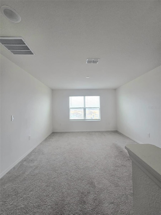 1603 Gardiner St, Haines City, FL 33844 - unfurnished room featuring a textured ceiling, carpet, and visible vents
