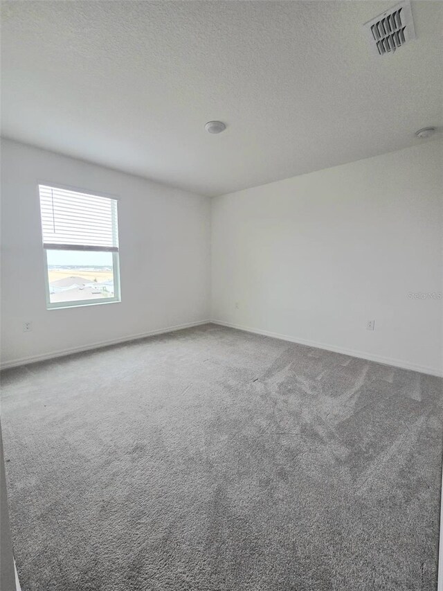 1603 Gardiner St, Haines City, FL 33844 - carpeted empty room with baseboards, visible vents, and a textured ceiling
