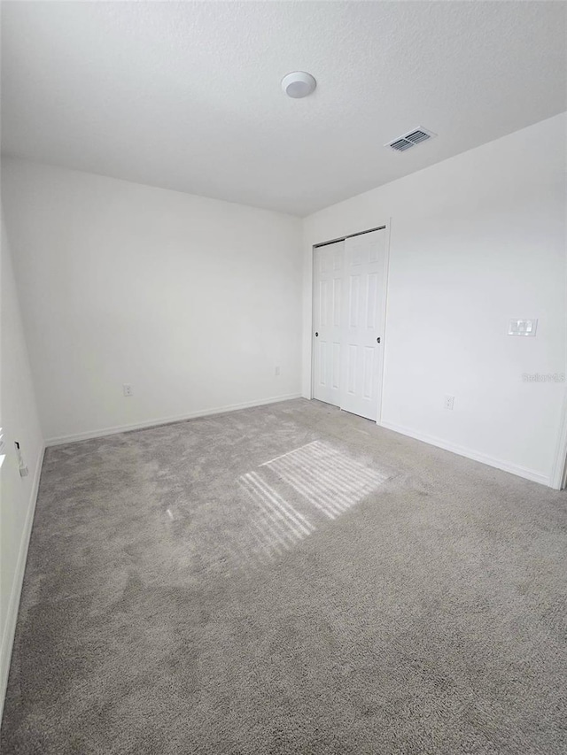 1603 Gardiner St, Haines City, FL 33844 - carpeted empty room featuring baseboards, visible vents, and a textured ceiling