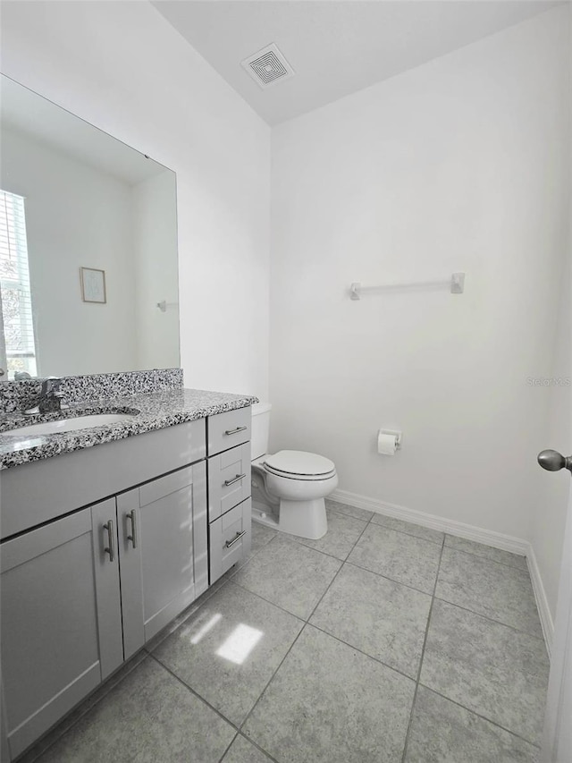 1603 Gardiner St, Haines City, FL 33844 - bathroom with toilet, baseboards, visible vents, and vanity