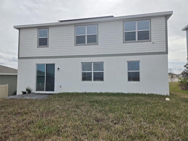 1603 Gardiner St, Haines City, FL 33844 - rear view of property with a lawn and stucco siding