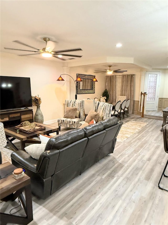 living room with ceiling fan and wood-type flooring