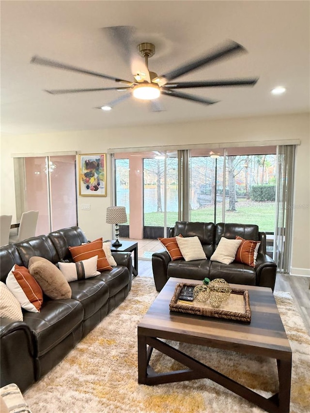 living room featuring ceiling fan and light hardwood / wood-style floors