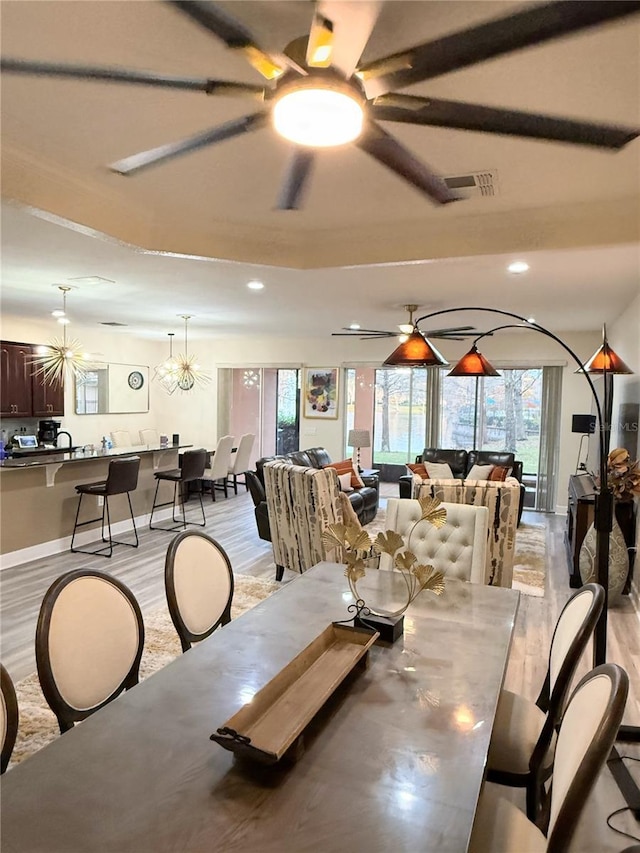 dining room featuring ceiling fan and light hardwood / wood-style floors