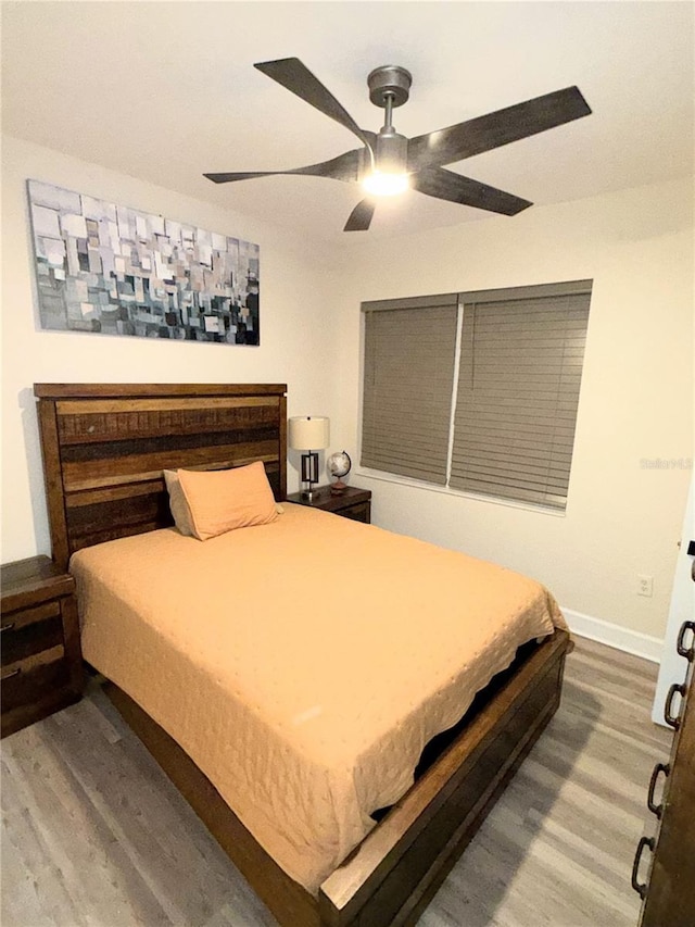 bedroom with ceiling fan and hardwood / wood-style floors