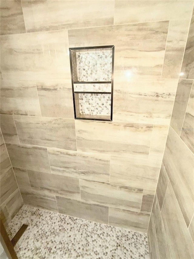 bathroom with tiled shower