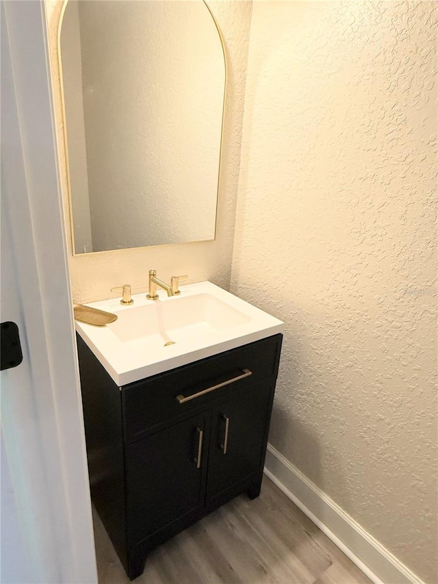 bathroom with vanity and hardwood / wood-style flooring