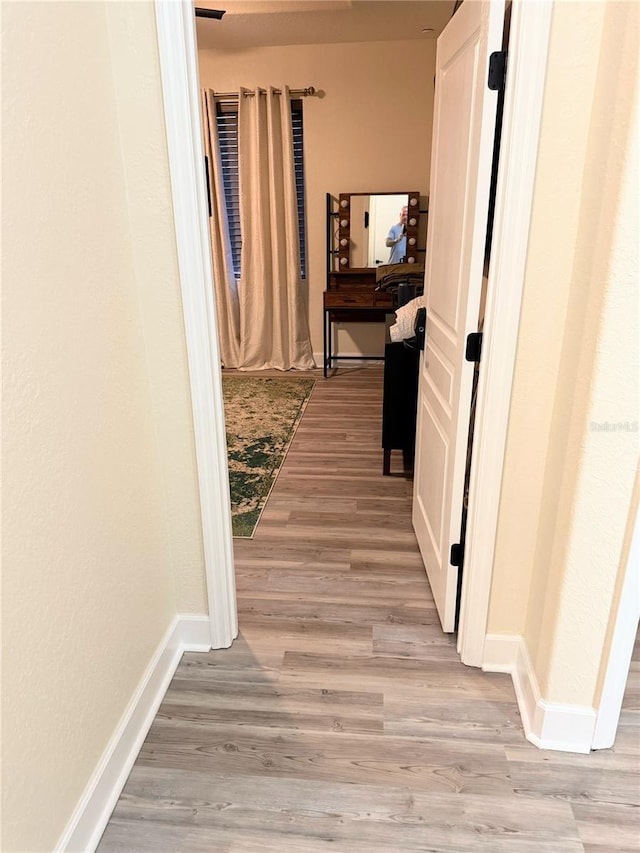 corridor with light wood-type flooring