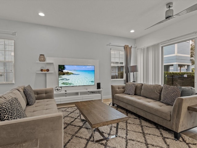 living room with ceiling fan, light hardwood / wood-style floors, and a healthy amount of sunlight