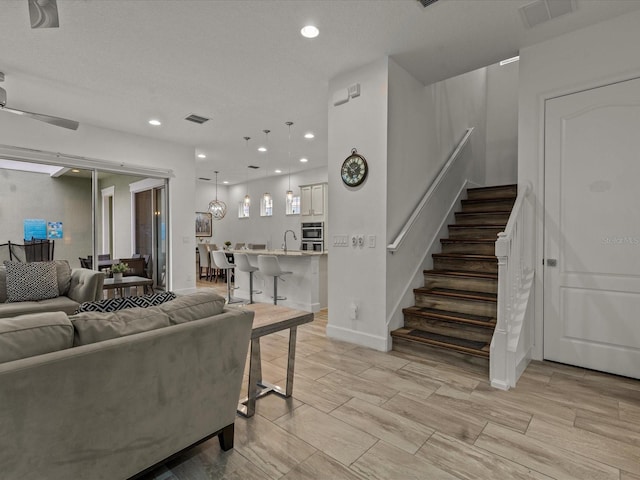 living room with sink and ceiling fan