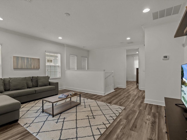 living room featuring crown molding and hardwood / wood-style flooring