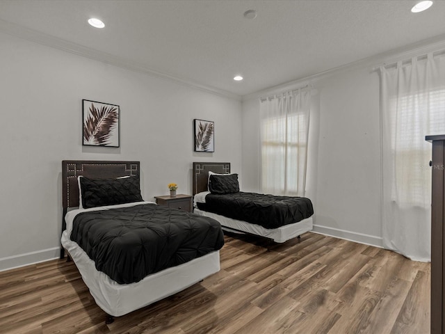 bedroom featuring crown molding and hardwood / wood-style floors