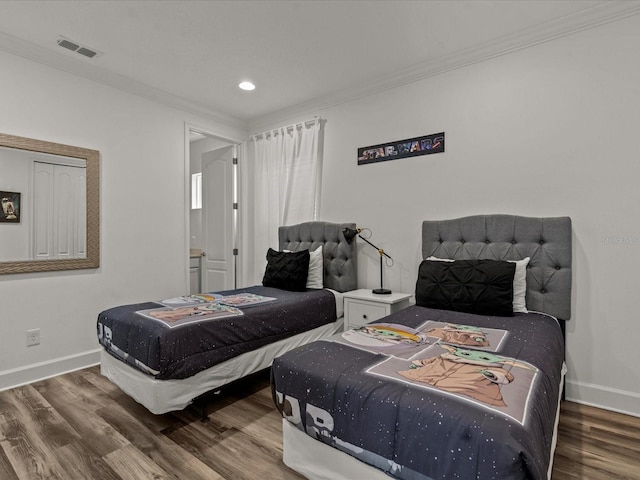 bedroom featuring hardwood / wood-style flooring and crown molding