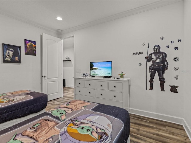 bedroom with ornamental molding and hardwood / wood-style floors