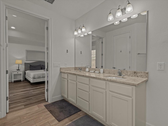 bathroom with vanity and hardwood / wood-style floors