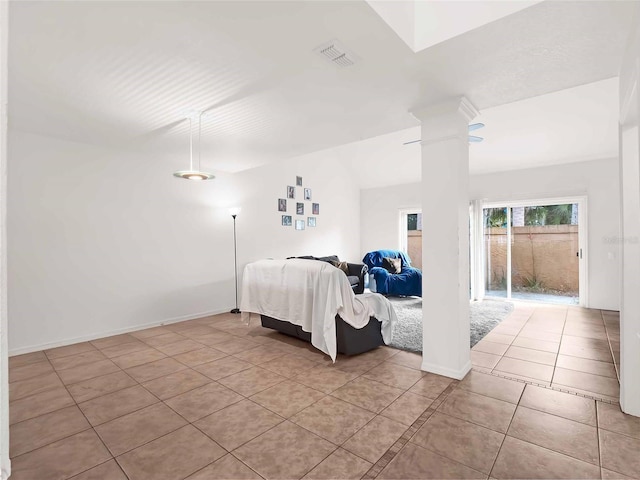 unfurnished bedroom with ornate columns and light tile patterned floors