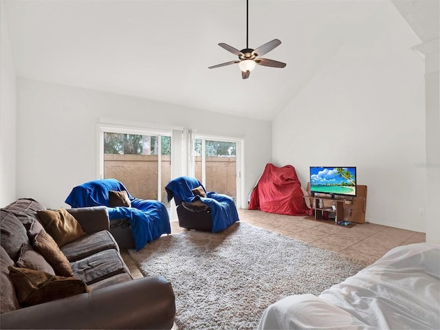 living room featuring ceiling fan, light tile patterned floors, and high vaulted ceiling