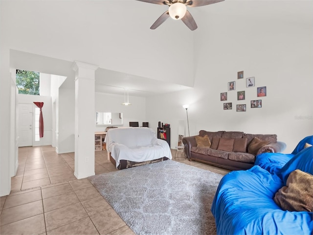 bedroom with ceiling fan, light tile patterned floors, and decorative columns