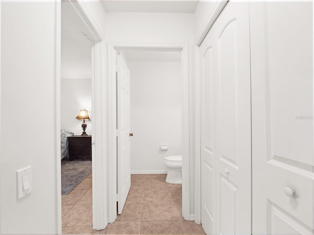 hall featuring light tile patterned floors