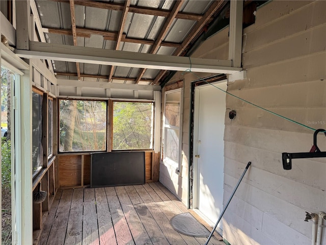 unfurnished sunroom featuring lofted ceiling