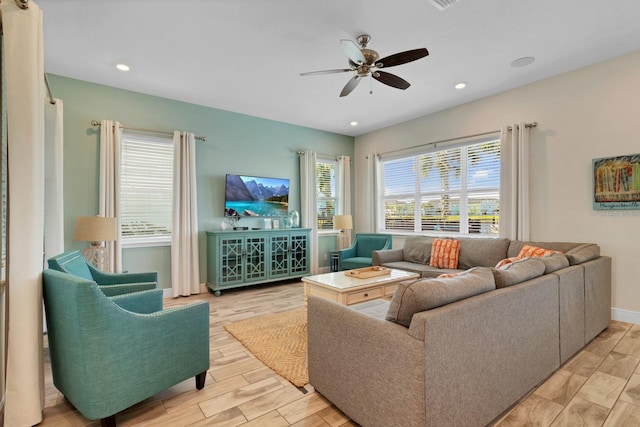 living room with plenty of natural light and ceiling fan