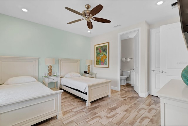 bedroom with ensuite bathroom, ceiling fan, and light hardwood / wood-style floors