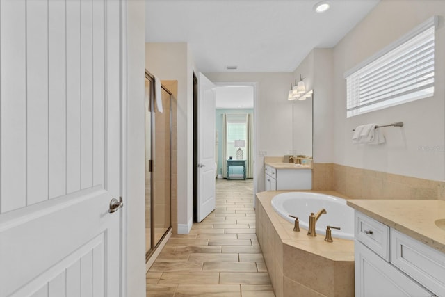 bathroom with vanity and plus walk in shower