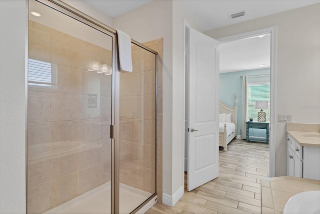 bathroom with vanity and a shower with shower door