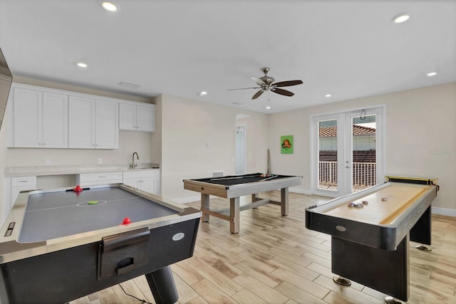 game room featuring sink, ceiling fan, pool table, french doors, and light wood-type flooring