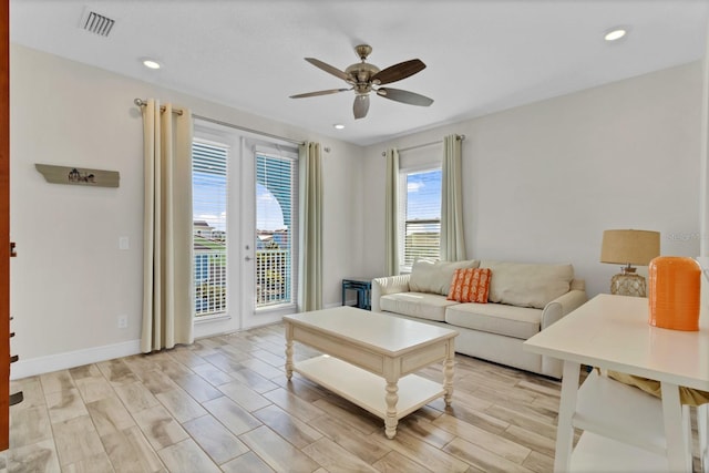 living room with ceiling fan and french doors