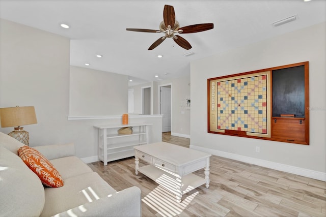 living room with ceiling fan and light wood-type flooring