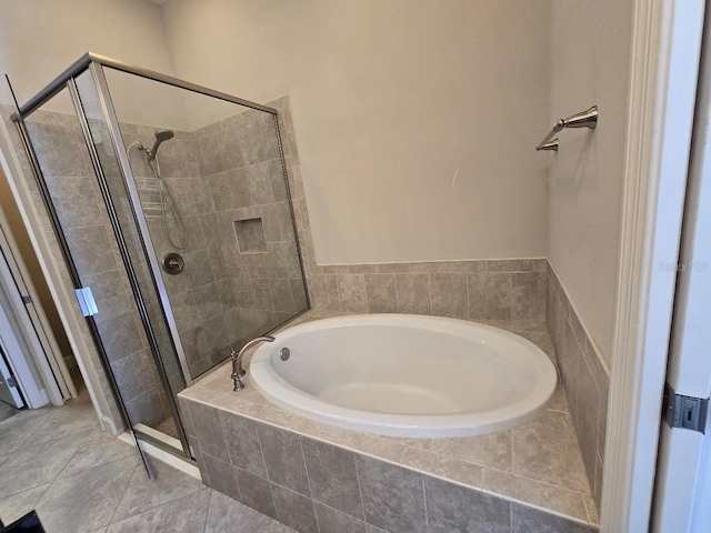 bathroom with independent shower and bath and tile patterned flooring