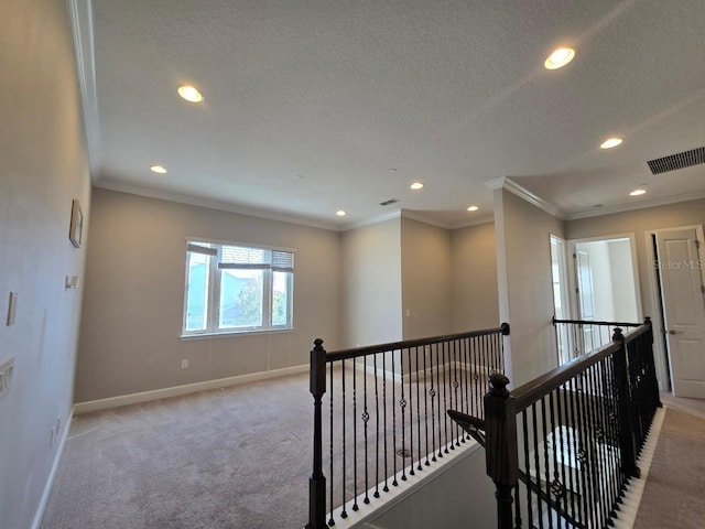 corridor featuring ornamental molding and light carpet