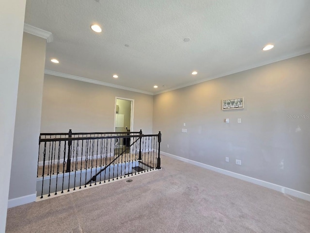 carpeted spare room with crown molding