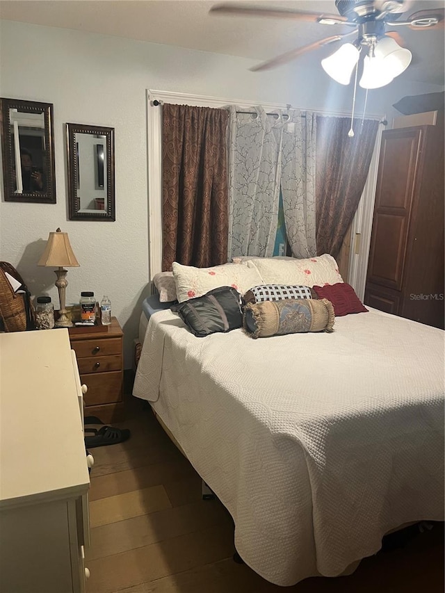 bedroom with hardwood / wood-style floors and ceiling fan